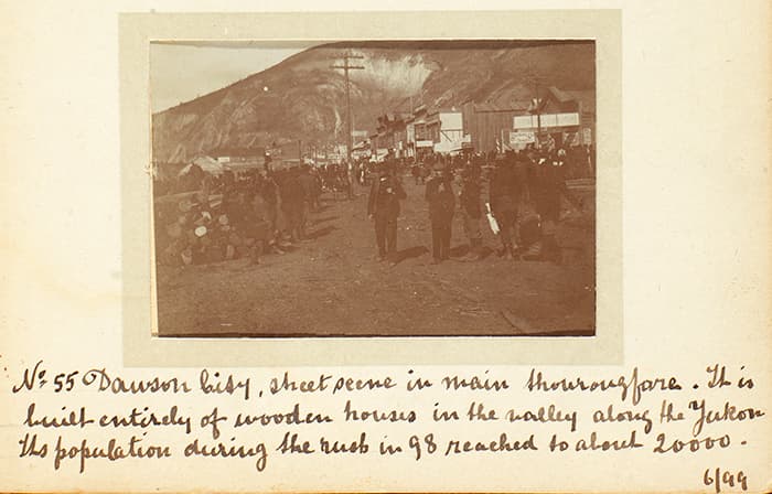 Detail of a page from Alfred and Charles O’Meara’s photograph album showing a street scene in the bustling boomtown of Dawson City, June 1899