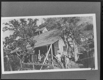 The staff standing on the porch and steps of the hospital at the Kern River Headquaters Camp at Kern River #1 Hydro Plant