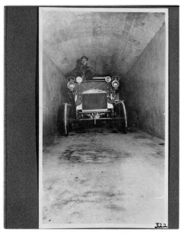 A man driving an automobile through the tunnel at Kern River #1 Hydro Plant