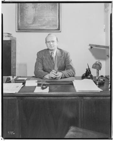 Manager of Beverly Hills Printing Office at his desk