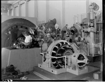 Crew doing repairs on Pelton water wheel used in Powerhouse # 1