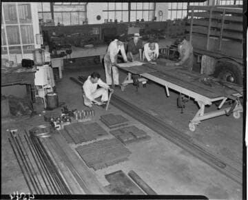 Men reviewing plans on work bench