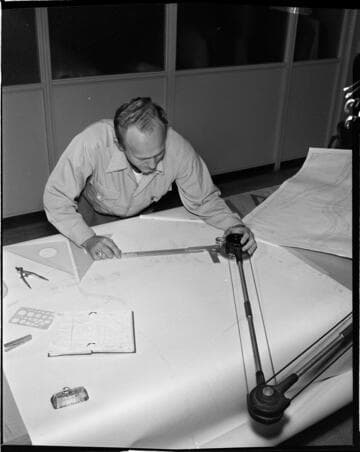 Draftsman woking on drawing at drafting table