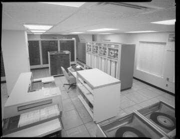People working in computer room with 1" tape drives