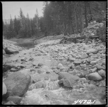 Big Creek, Vermilion Dam - Junction of service spillway channel and toe drain outlet channel dam end condition, causing back water to flood. Flood 28+25 weir and wells