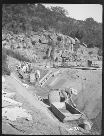 A construction crew plastering a ditch at Tule Plant