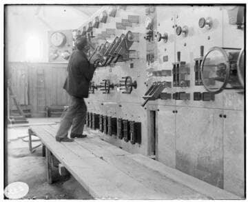 A man conducting a first aid demonstration at the switchboard of Mill Creek #3 Hydro Plant