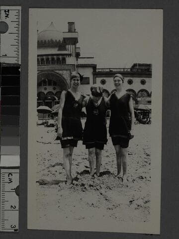 Three women on the beach in front of Ocean Park Bath House