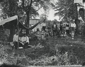 Temporary Cheyenne camp during Grand Council meeting, 1875. At left, interpreter Philip McClusker and his Cheyenne Indian wife, Minnehaha
