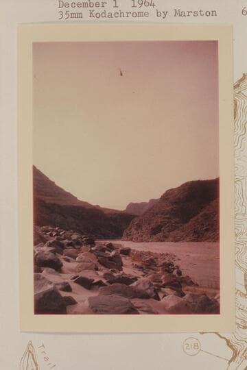 Downriver from lower end of 217 Mile Rapid showing chopper flying out for a load of freight