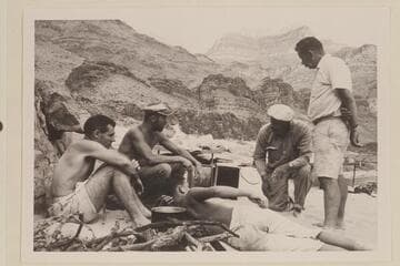 Camp at lower end of Stanton's Switching Yard.  Between Bass Cable and Shinumo Creek.  Garth Marston at left; then Larry Sanderson, John Schulz, and Chuck Richey.  Buzz Belknap is lying in the foreground
