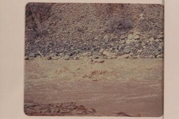 Les Jones in his canoe-type of boat in Dubendorff Rapid. "Jones ran it down the middle.  Really disappeared in a hole." Smith journal entry