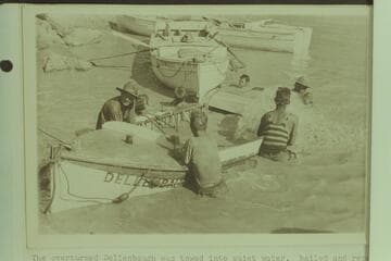 The overturned "Dellenbaugh" was towed into quiet water, bailed and repaired