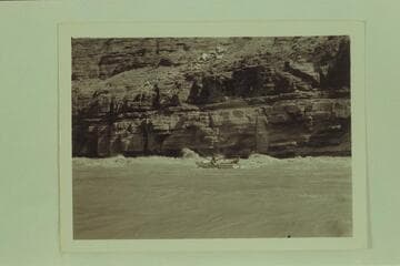 Wayne McConkie at the oars of the "Joan" with Garth Marston on the after deck; Upset Rapid