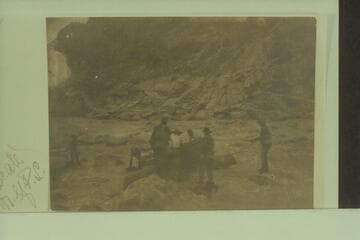 Third photo in Stanton's series of snap shots of a portage by his crew: "Rest Awhile."