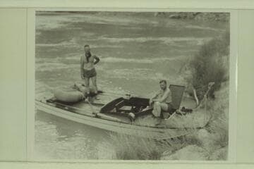 The "Esmeralda II" at camp at the foot of the Tanner Trail.  Ed Hudson stands on the deck.  Bestor Robinson sits at right