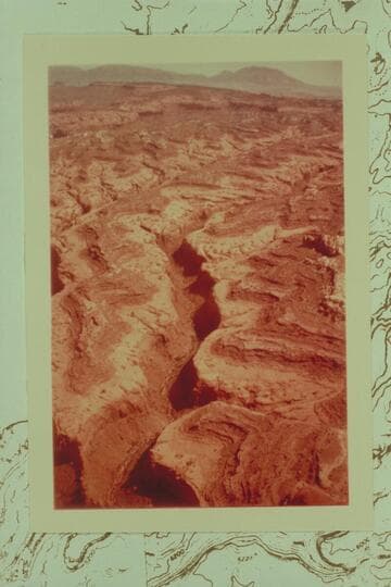 Northeast across East Moody Canyon to the higher part of the Waterpocket Fold and the Henry Mountains