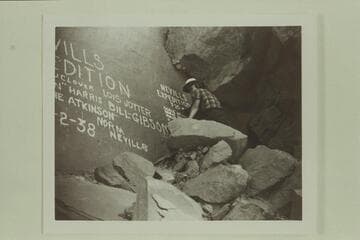 Doris Nevills posed at the names of the Nevills party, Cataract Canyon