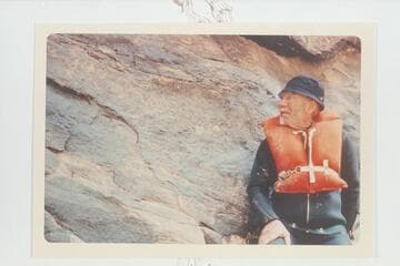 Dock Marston posed by the 1836 D Julien inscription in Cataract Canyon, Mile 185.75