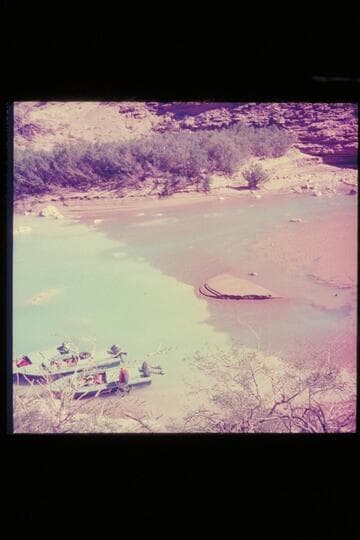The three boats of the 1954 outboard fleet moored in the clear lagoon at the mouth of the Little Colorado