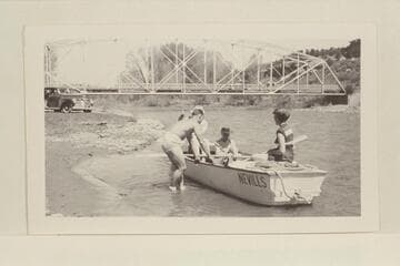 The start of the boat trip down the Dolores River.  Dolores, Colorado.   Pres Walker shoves the boat off from the shore.  Left to right in boat:  Marston, Margaret Marston, Becky Walker.  Photo #2:  left to right, boat in stream:  See Note field
