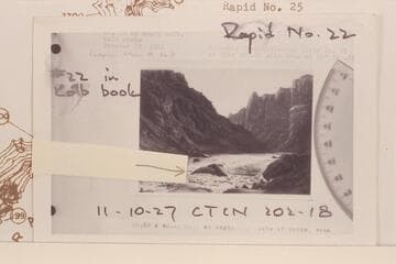 Copy of print of Kolb photo showing the head of Rapid 22 in The Big Drop of Cataract Canyon with a marker placed by William J. Davis to show the same rock which appears in his photo of 1964, July 07