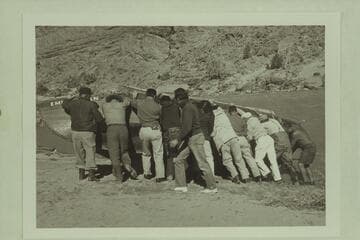 The "Emma Dean" being rolled for attaching a cable.  Above Moab and below Castle Creek.  Filming of "The Colorado River Story" by Disney