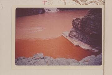 The red water of the Supai flood mixing with the coffee and cream of the Colorado