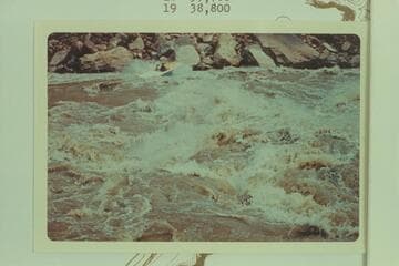 The "Wee Yellow" down Soap Creek Rapid.  Bill Austin runs down after topping the rapid on a test run.  Dock Marston was a passenger