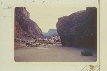 Camp on sand bar at overhanging rock above 25 Mile Rapid.  The rock at right may be Hansbrough-Richards Ledge, Mile 24.85