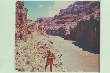 Little John photographing the area where the Dead Man lies above Paradise Canyon.  Boats in background.  Preliminary Lees Ferry gauge:  122,000 cfs