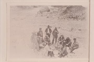 Part of the Pathe-Bray Co.  Dick Muller and Ray Tankersley in background.  Dick with coffee cup almost to mouth.  Jack Harbin is seated with clasped hands just to right of Dick Muller.  John Boles is seated second from right