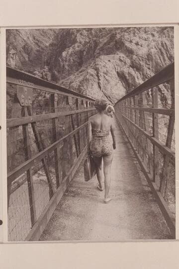 Margaret Marston crosses suspension bridge to right bank.  Bright Angel Creek
