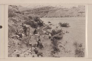 Camp below Mendenhall Loop where flood drove us out.  Loper eating.  Left to right:  Christensen, Allen or Trimble, Miser, Hyde, Loper, Blake