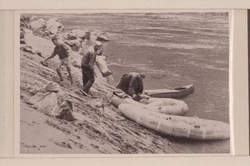 Rogue River party of UC students; six in the party.  Traverse of Rogue River with life rafts and a canoe.  Loading at Whisky Creek