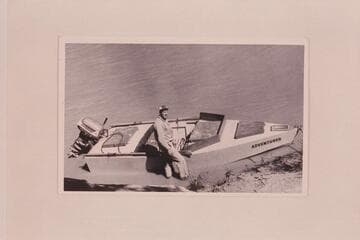 Al Morton's boat "Adventurer."  His son-in-law stands beside it.  The craft copies the sadiron lines with little acceptance of the usual design for power use