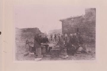 Stanton crew at Christmas dinner in front of the fort at Lees Ferry