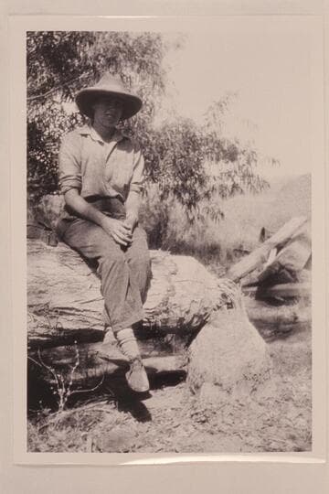 Sarah Fraser.  Glen Canyon.  Traverse from Hite to Lees Ferry.  Sitting on a beaver-cut tree