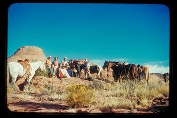 The crew of the Land Cruise of 1955 in Little Finger Canyon, a side canyon of Navajo Canyon.  Front:  Ballard Atherton, Bahe, Masland, Whitehat.  Standing:  Marston, Cutler, Visbak, Daly, a Navajo boy of the Manygoats family, Desloge