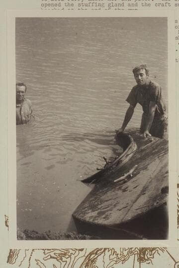 Duncan Harold McDermid at right.  Frank Barnes at left.  Lees Ferry.  The sunken launch "Canopy."  From negative in Waller collection