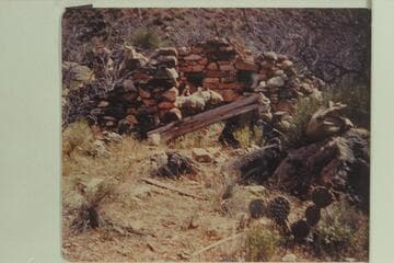 Boucher's rock cabin at junction of Boucher Creek and Trail Gulch.  Two National Park Service sleeping bags