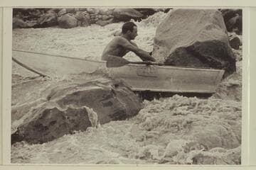 Norm Nevills in 13-Foot Rapid, San Juan River.  The flow is less than 400 cfs.  The boat is a 10 ft. folding spruce boat owned by Ansel Hall