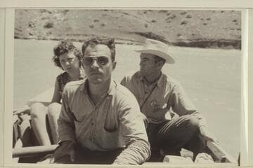 Skipper Frost at the oars in the Piute Farms section of the San Juan.  Mrs. Paul B. Meadows and Phillip T. Hayes