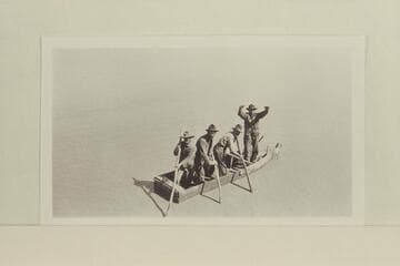 Crew members in plank skiff built at Camp Ibex