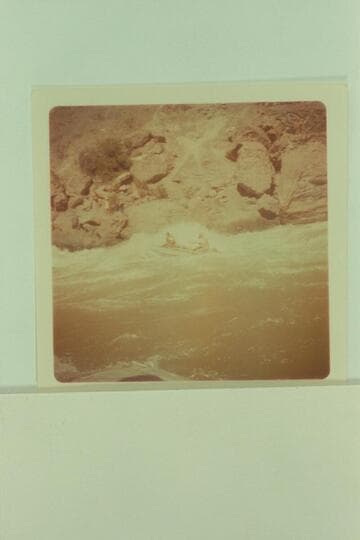 Small 4-man, oar-powered raft in Vulcan Rapid