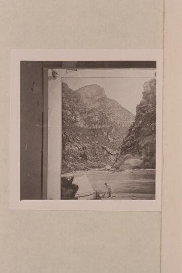 Emery Kolb setting up camp at the foot of Lodore Rapid; Triplet Falls