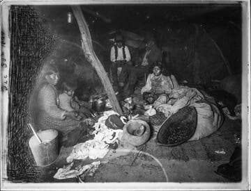 Family inside dwelling, 1899