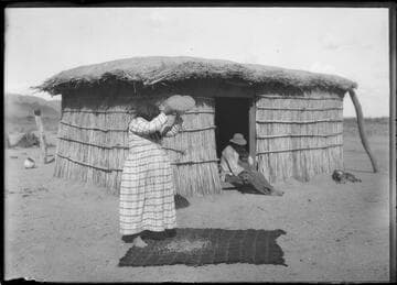 Woman winnowing grain