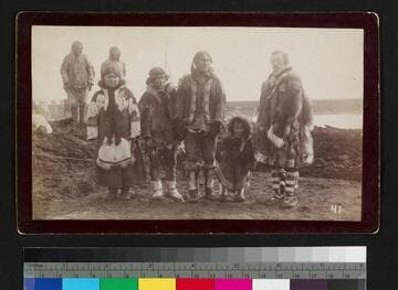 Alaska natives, possibly a family, with Caucasian man in fur coats