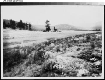 Field with ridges of hills in the distance at Vermejo Ranch